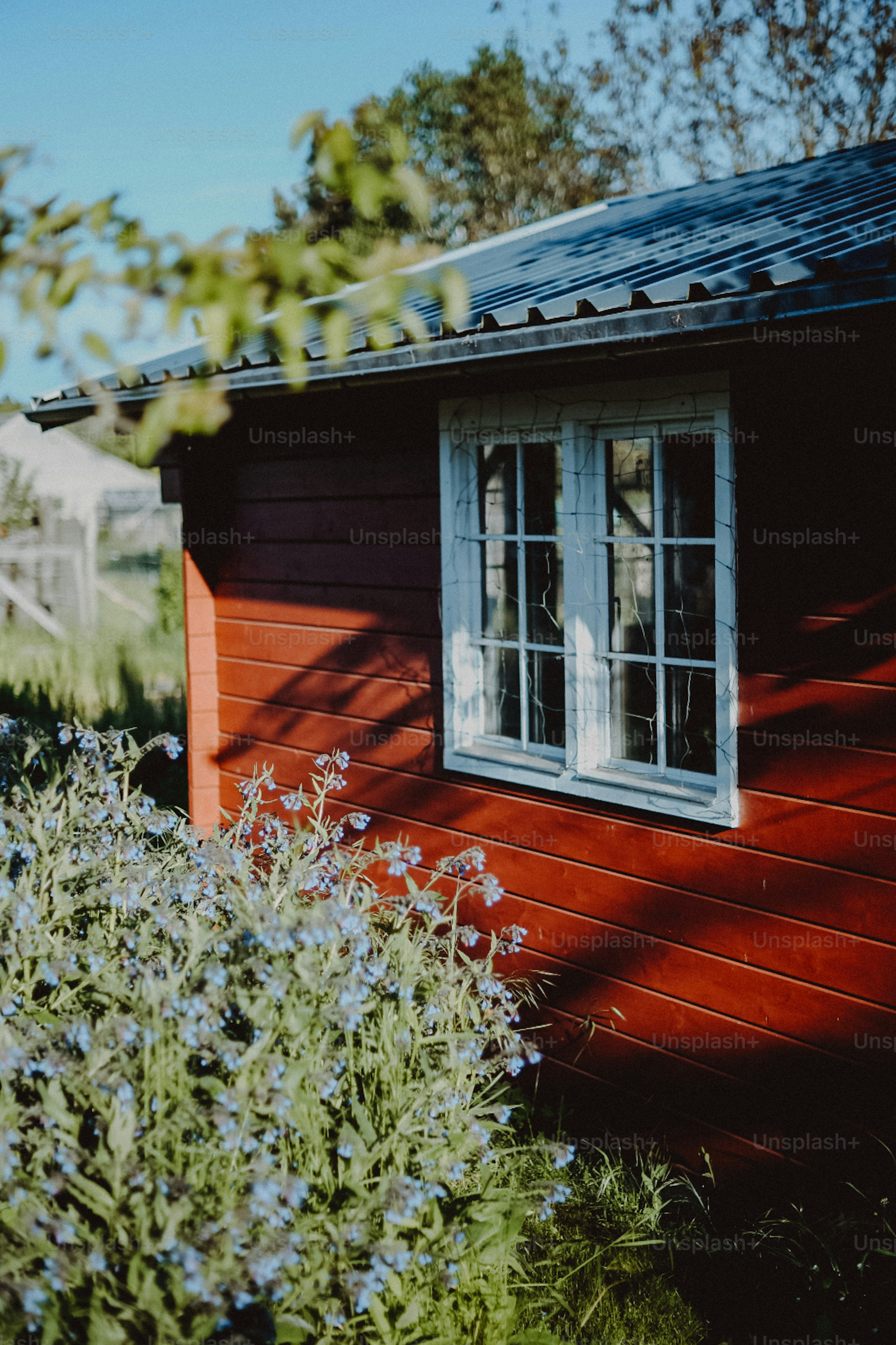 a small red house with a white window