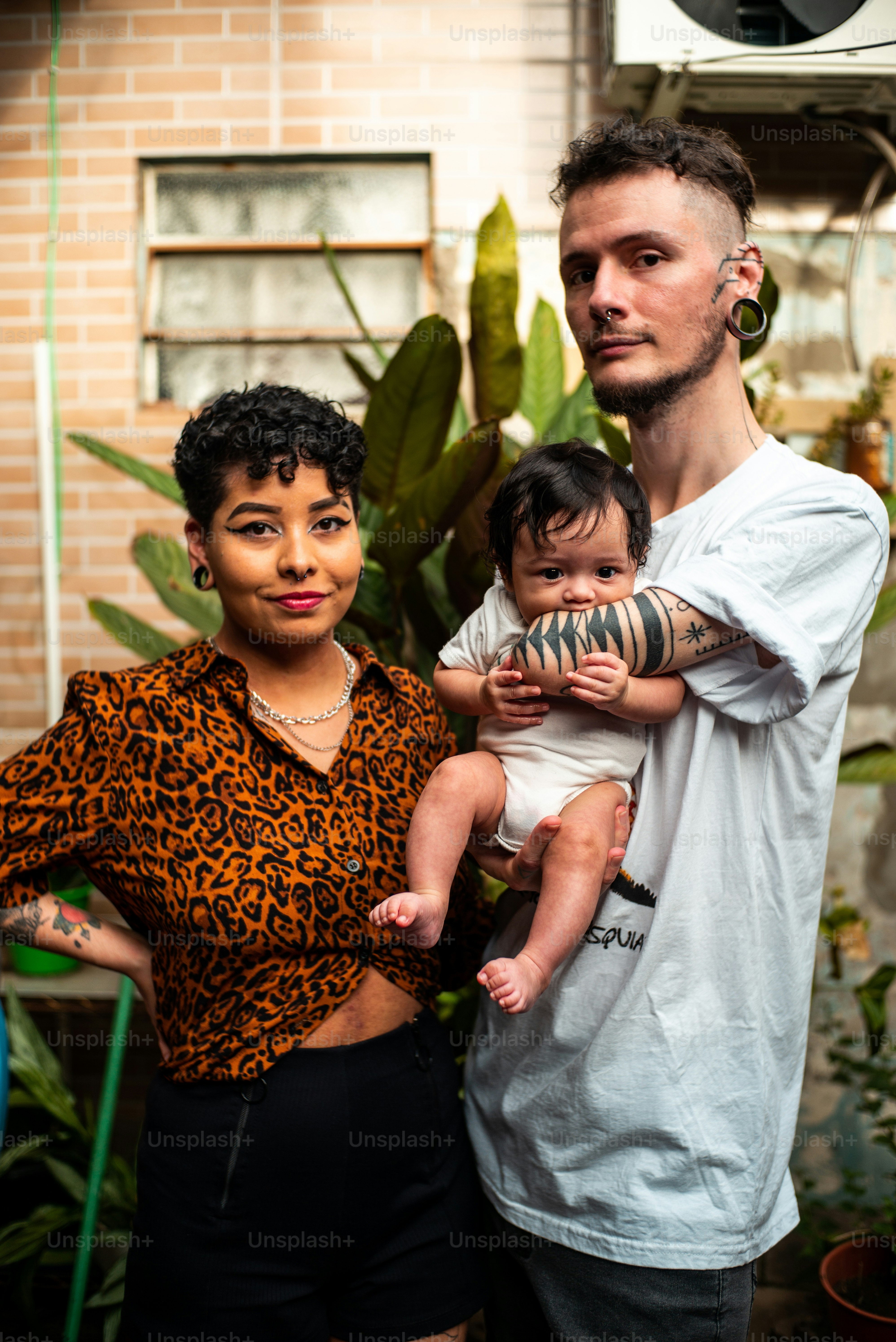 a man and woman holding a baby in their arms