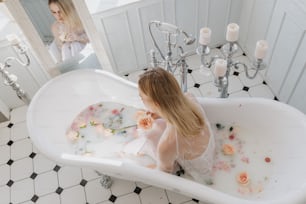 a woman sitting in a bathtub filled with water
