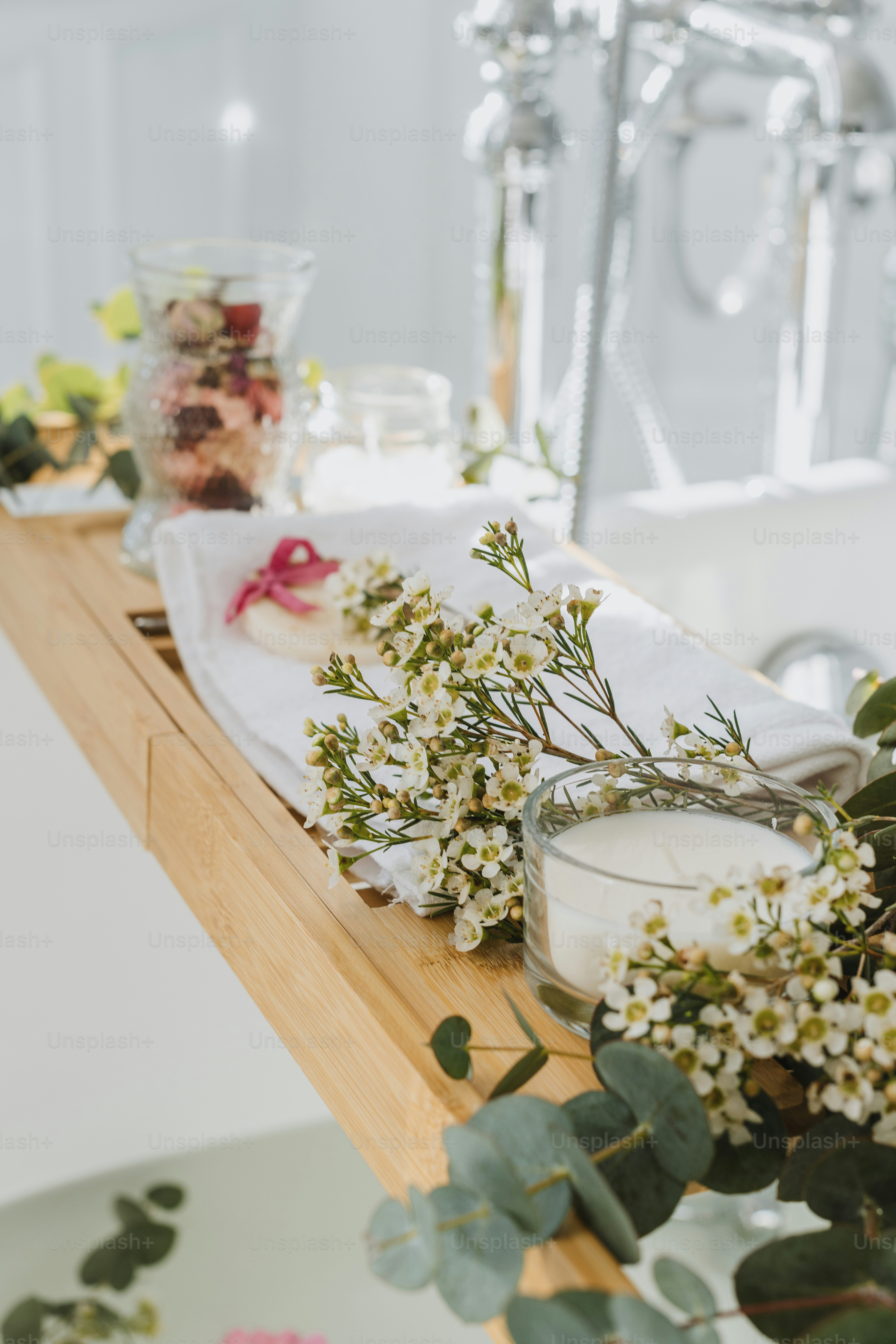 a wooden table topped with flowers and candles