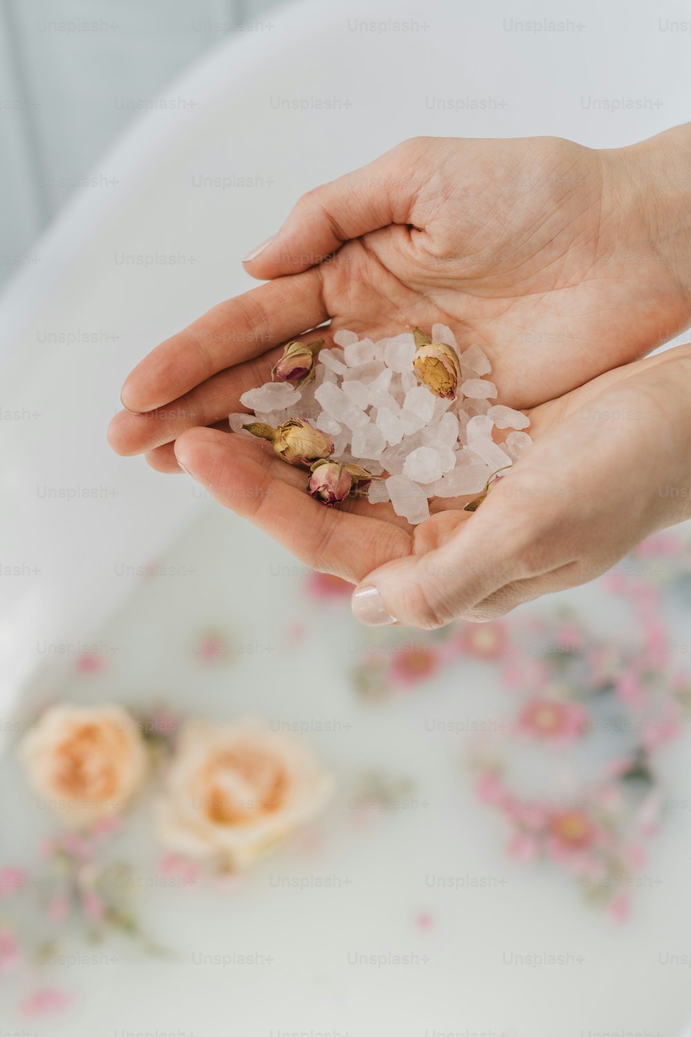 a person holding a handful of sea salt in their hand