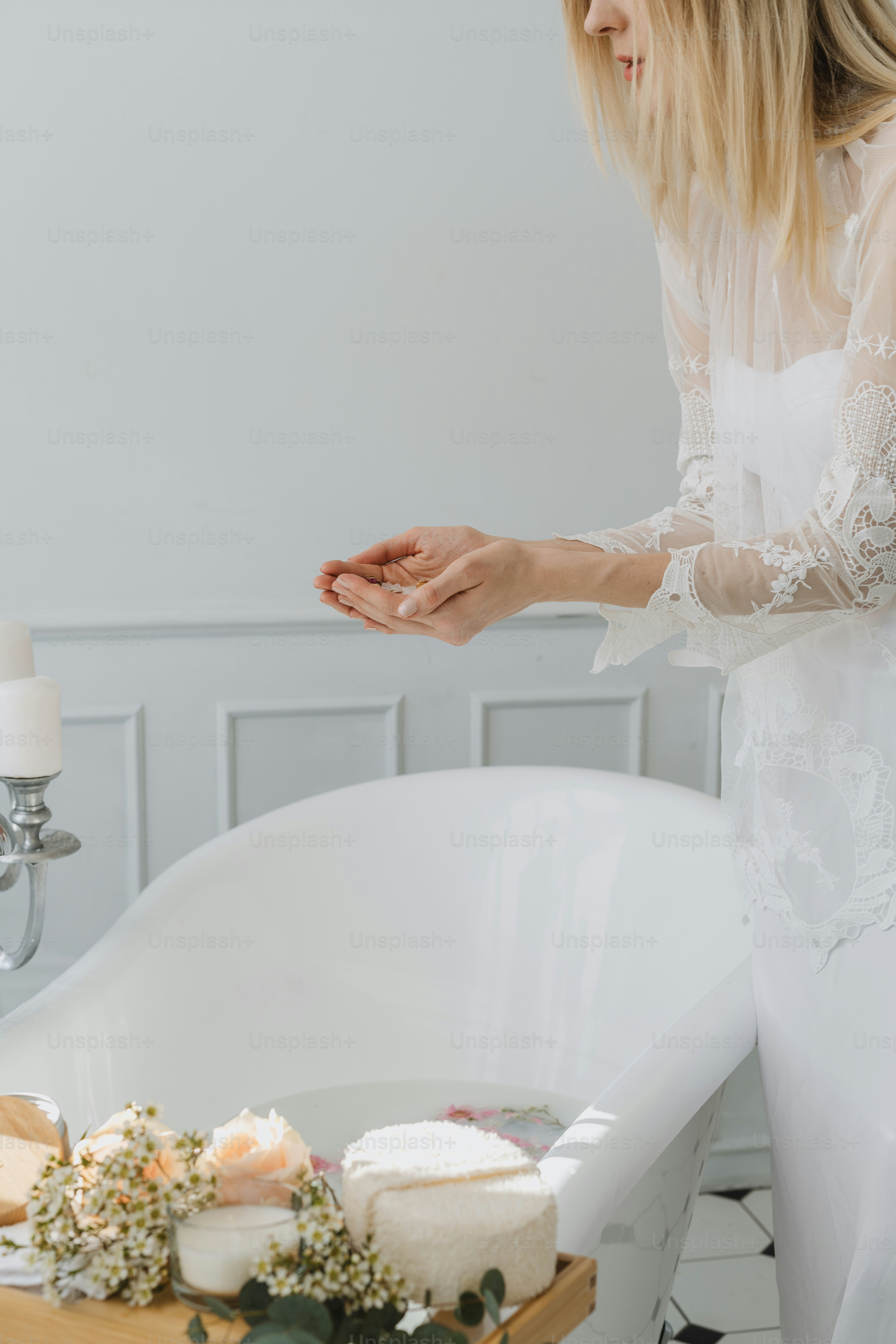 a woman standing in front of a bath tub