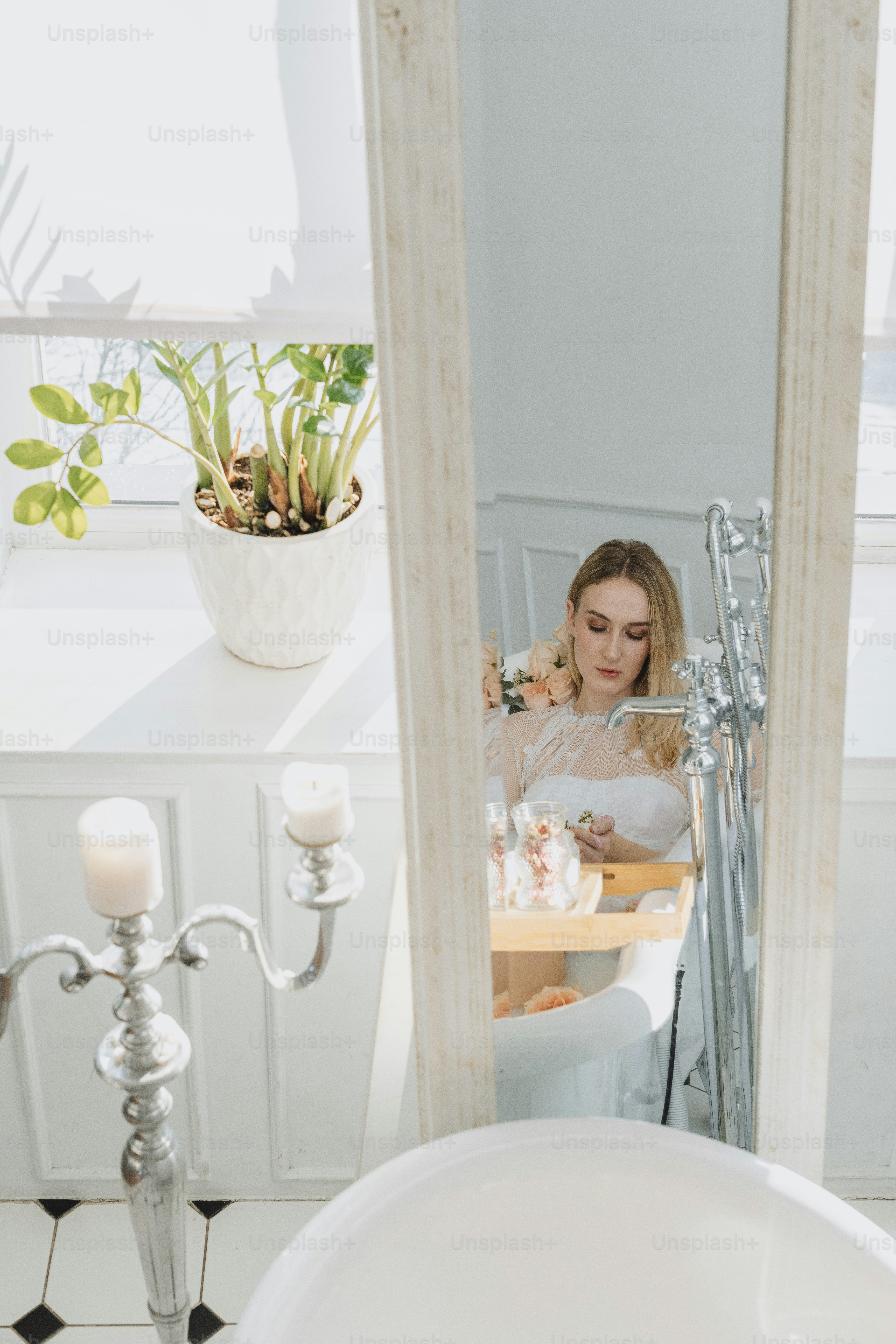 a woman sitting at a table in front of a mirror