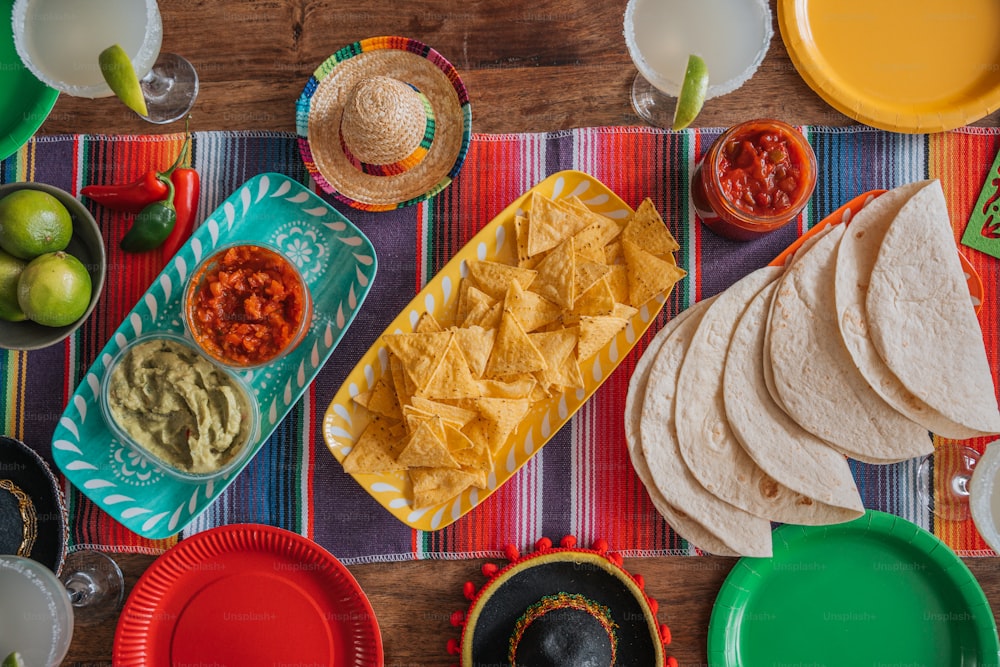 a table topped with plates and bowls filled with food