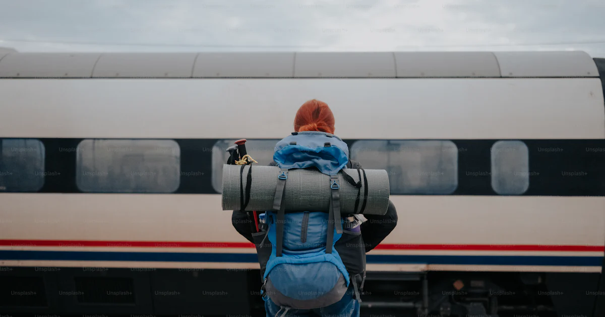 Guy Backpack Train A person with a backpack standing in front of a train photo – Adventure ...