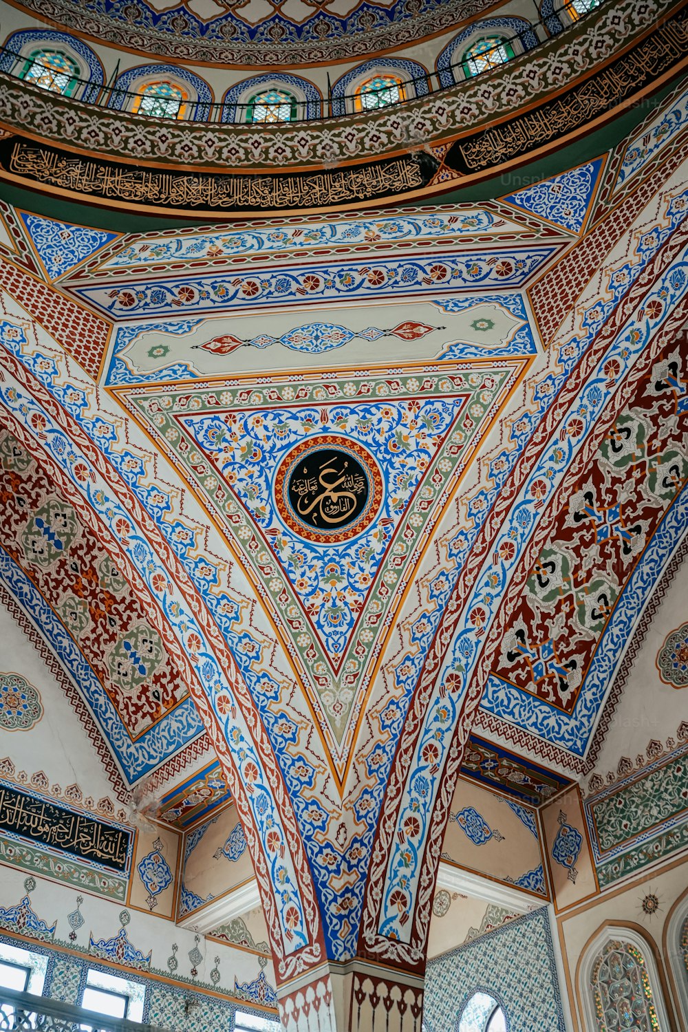 the ceiling of a building with a clock on it