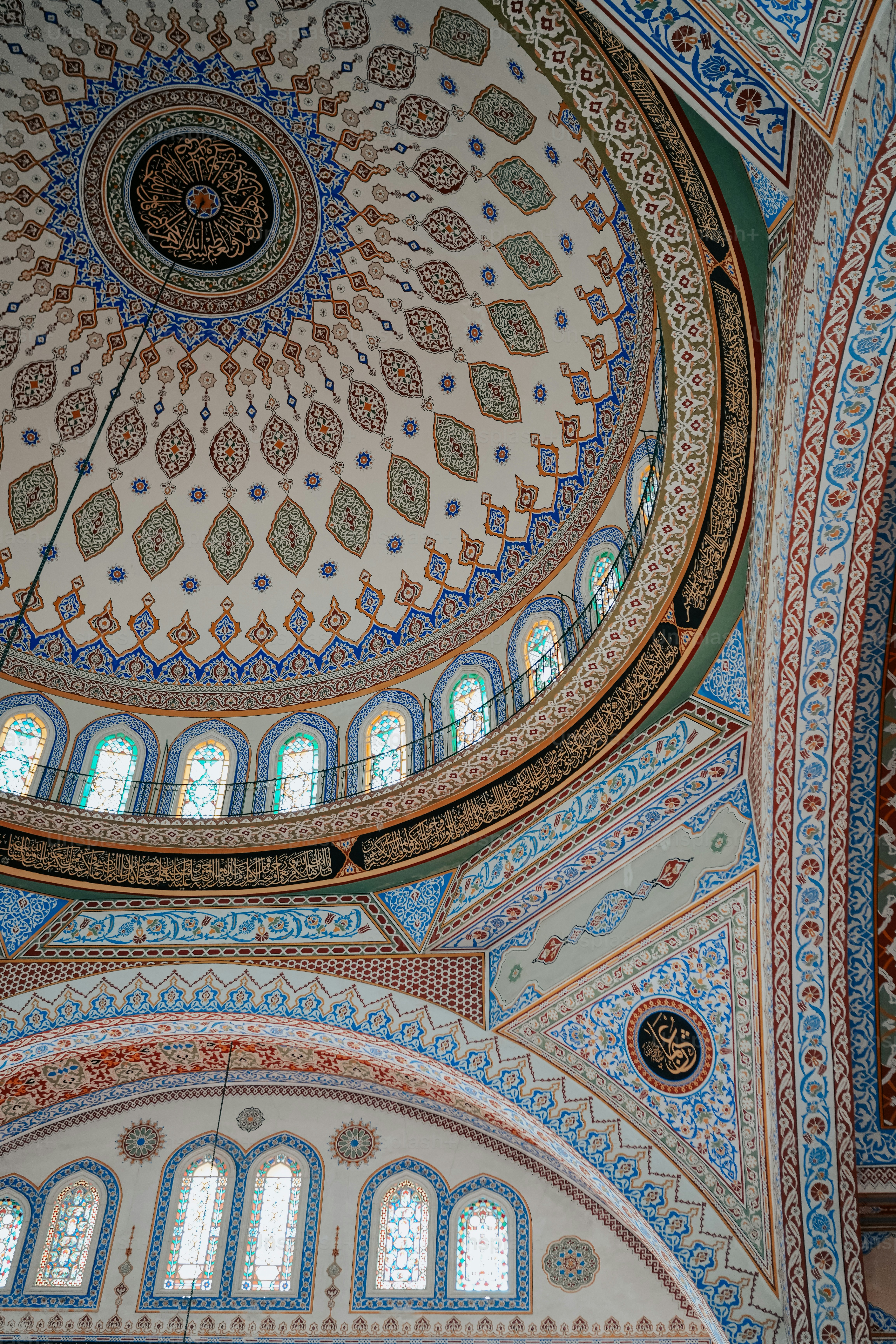 the ceiling of a large building with many windows