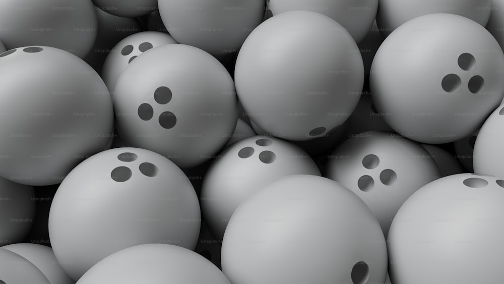 a bunch of gray balls with holes in them
