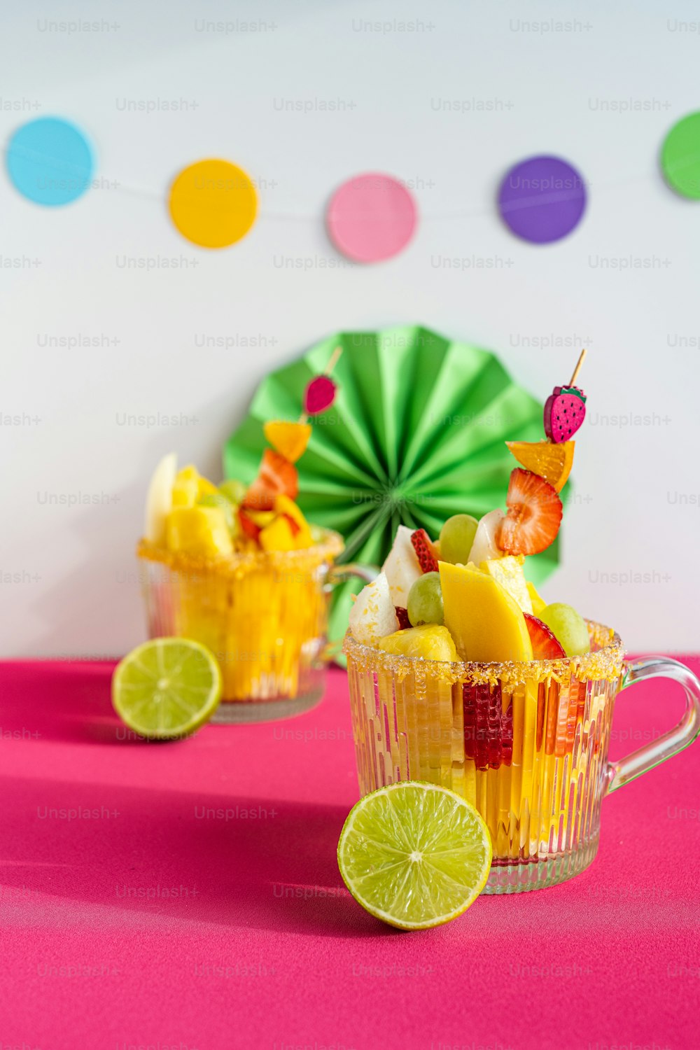 a couple of cups filled with fruit on top of a table