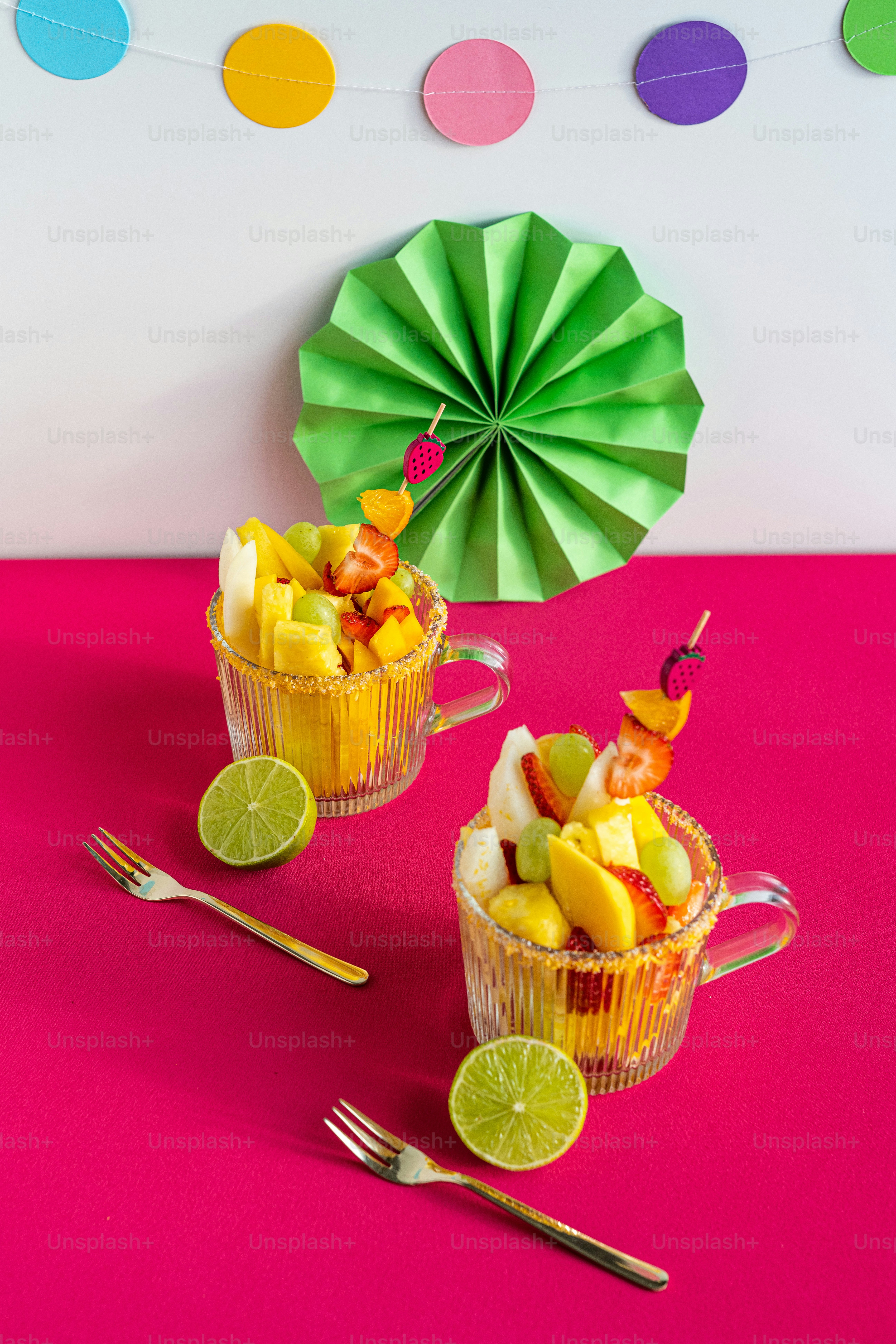 a couple of cups filled with fruit on top of a table