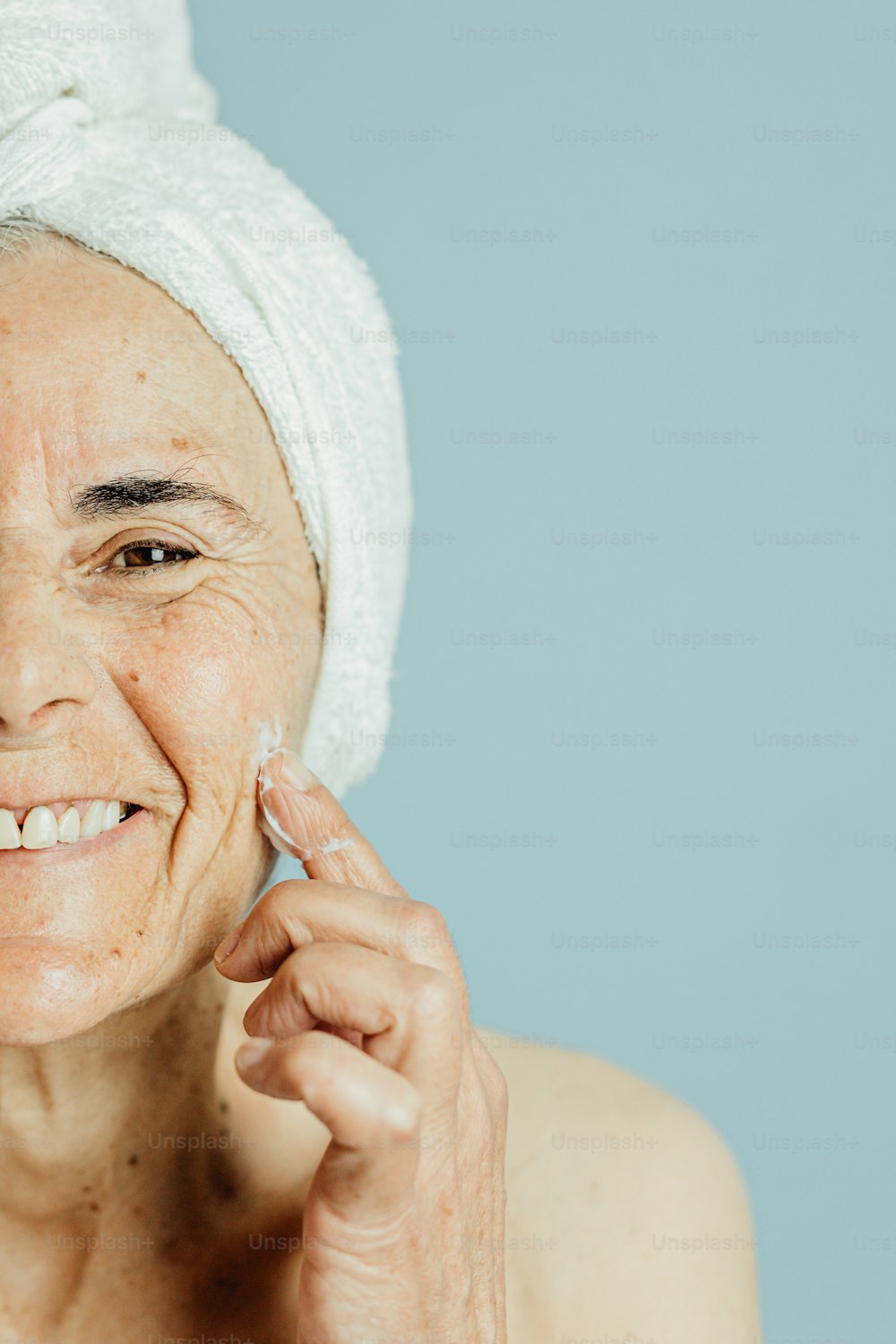 a woman with a towel on her head is smiling