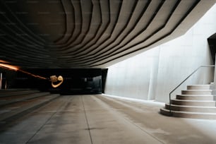 a staircase leading to a building with a light at the end of it