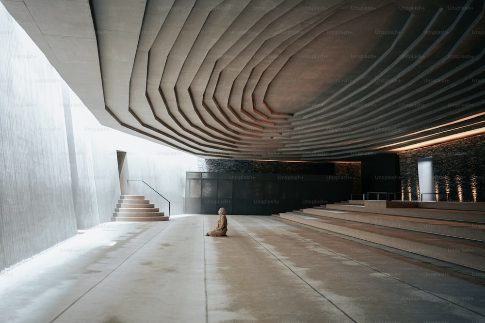 a person sitting on the floor of a building