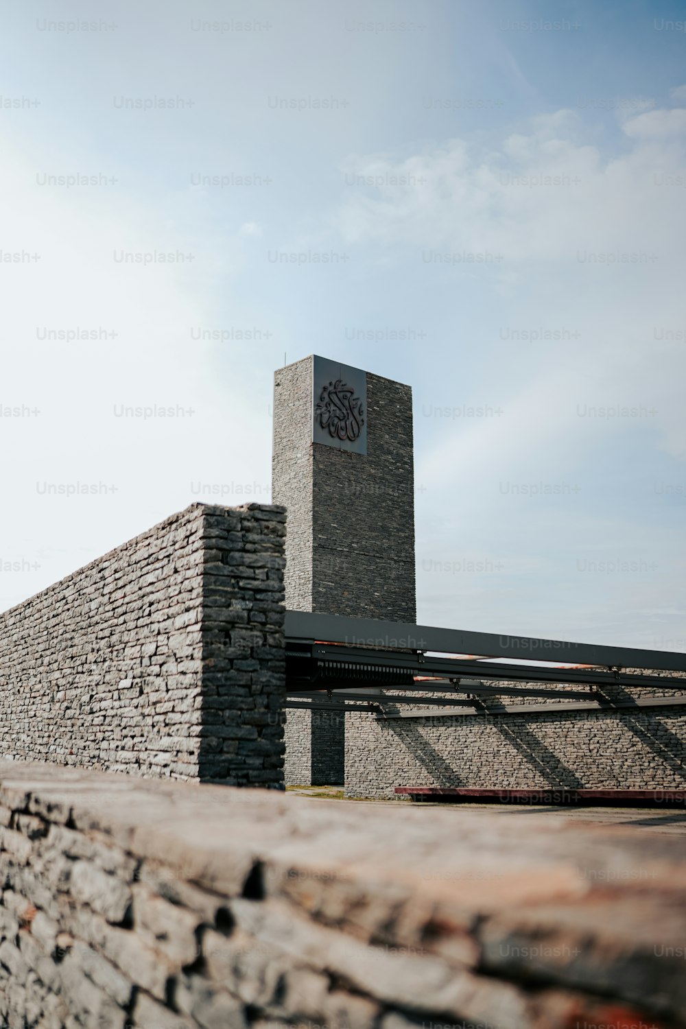 a stone wall with a clock on it