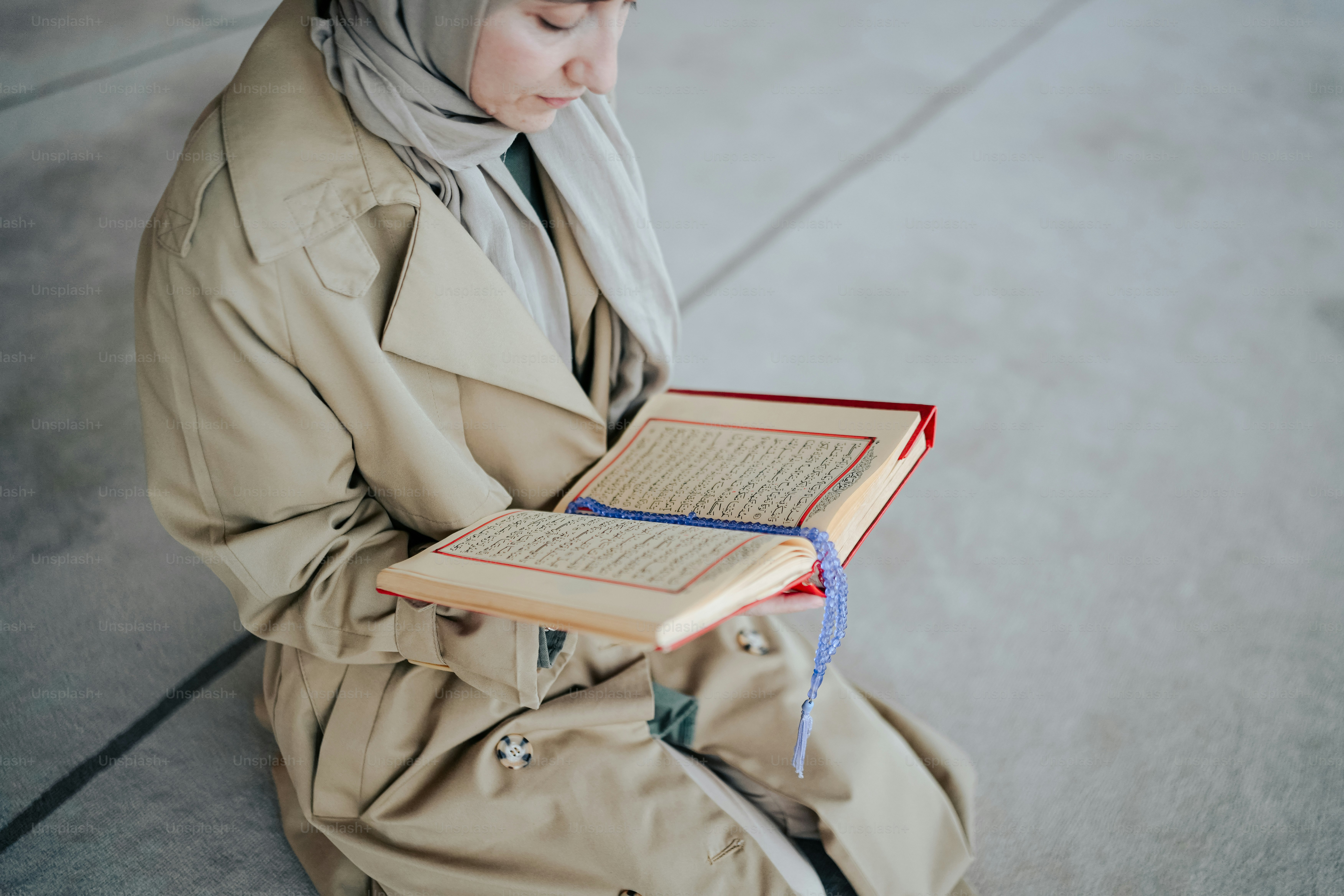 a woman sitting on the ground reading a book