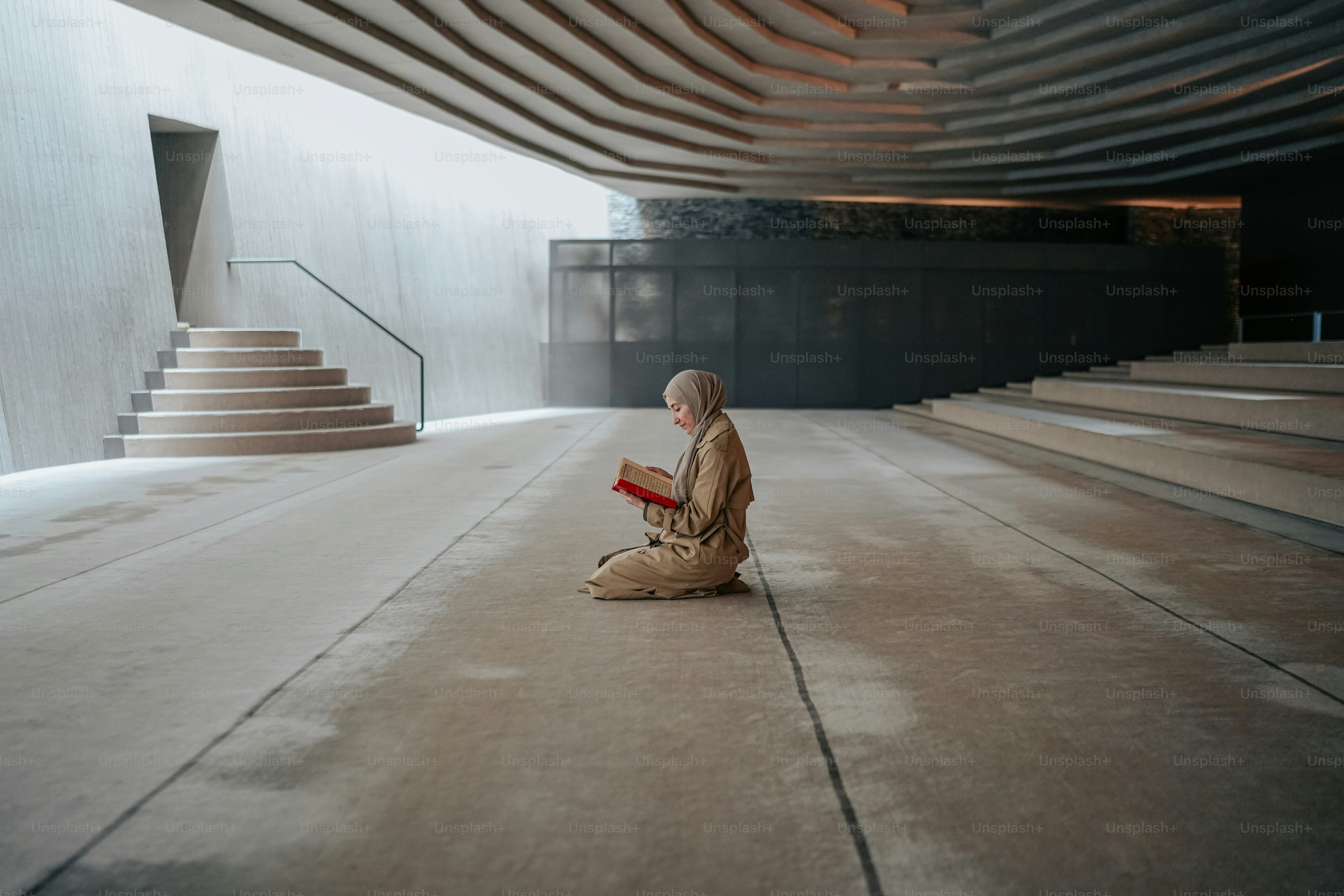 a person sitting on the ground reading a book