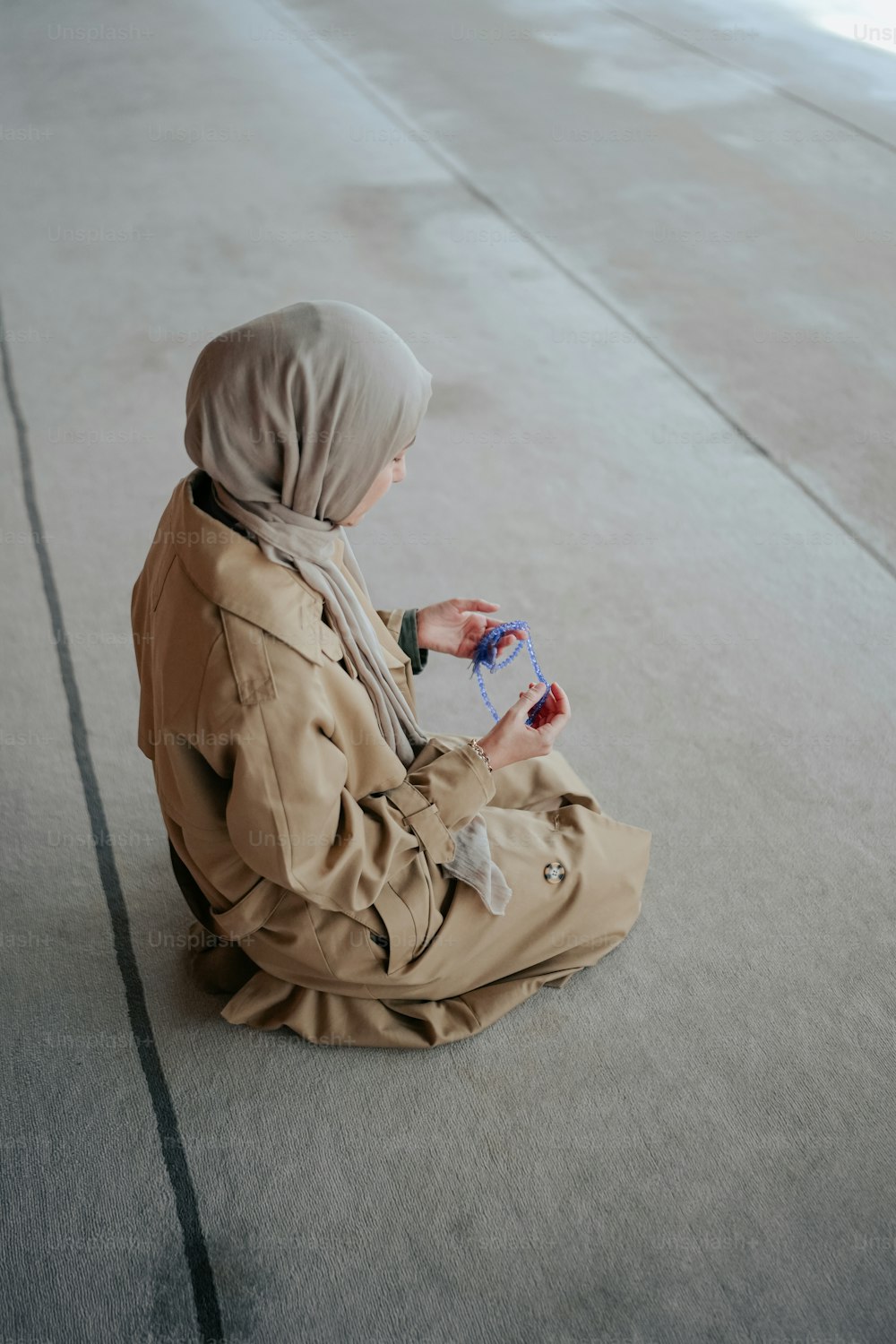 a person sitting on the ground with a bottle of water