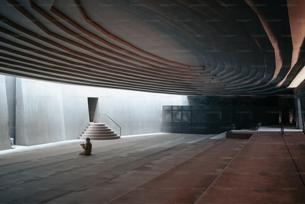 a person sitting on the floor of a building