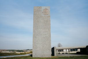 a tall brick tower with a clock on it's side