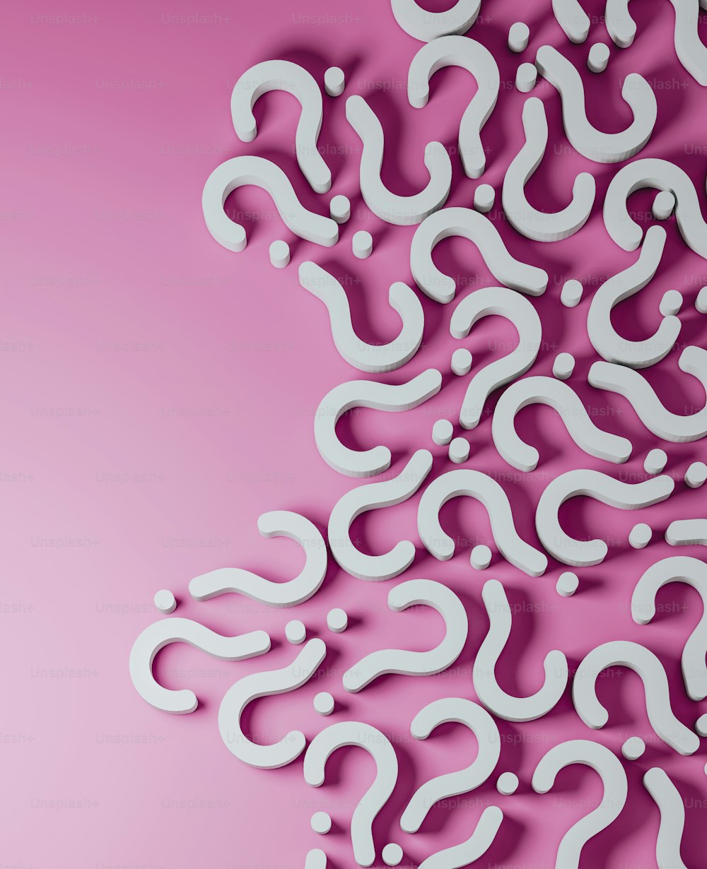 a pink background with a pattern of question marks