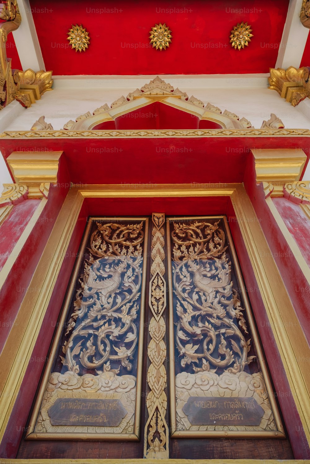 a red and gold building with two doors