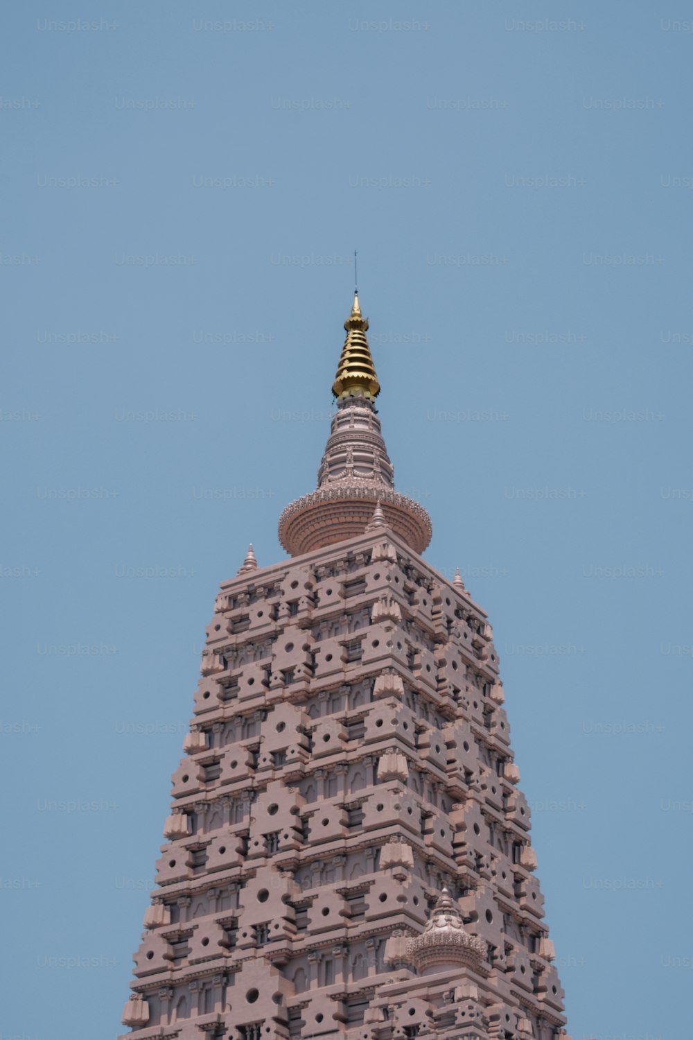 a very tall tower with a clock on it's side