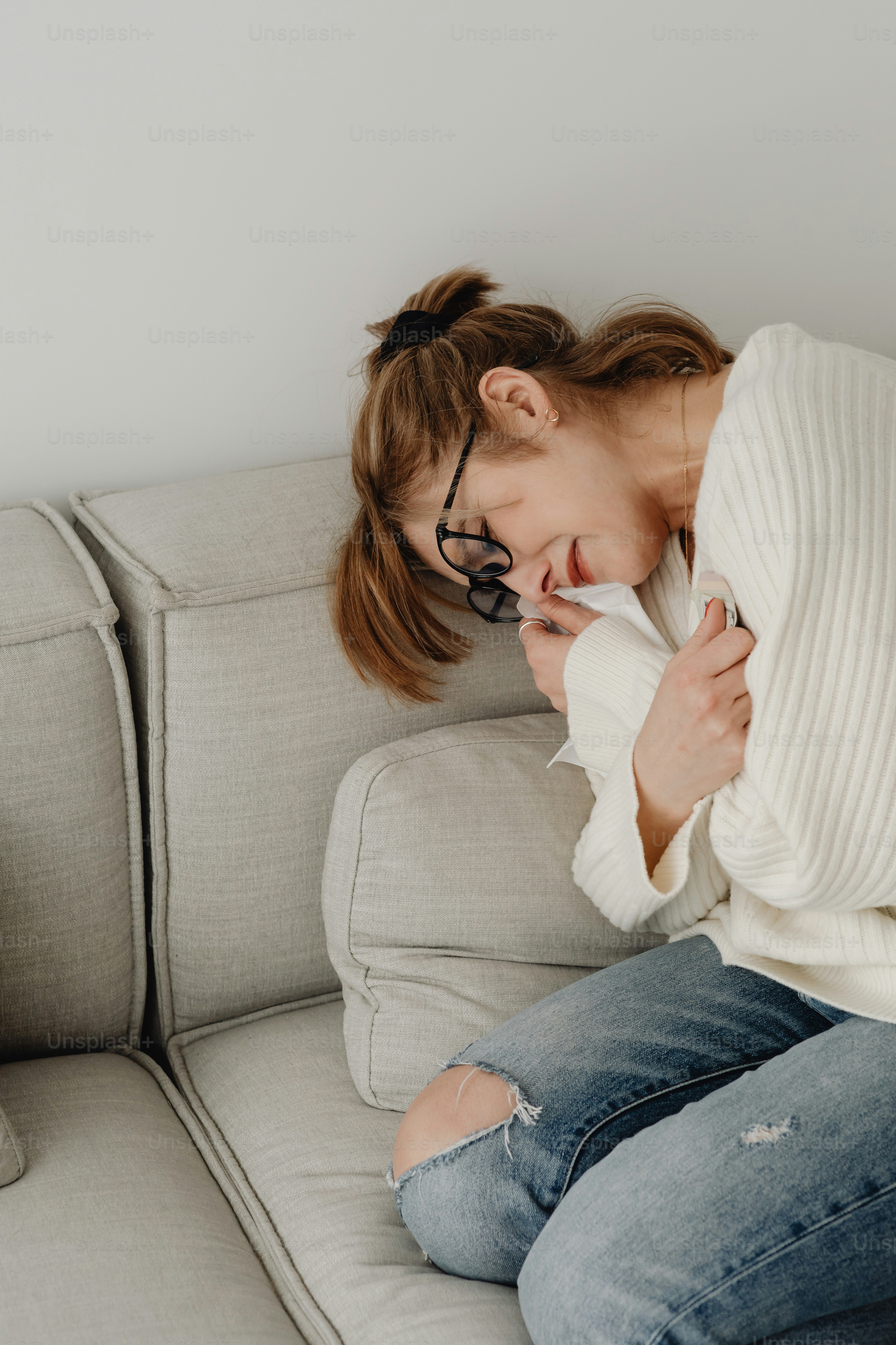 a woman sitting on a couch with her eyes closed