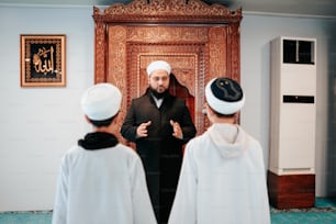 a man standing in front of two other men