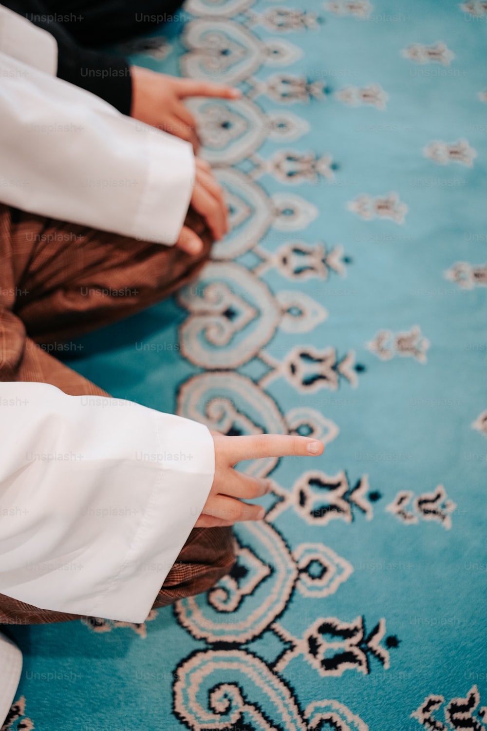 a close up of a person sitting on a rug