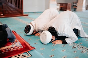 a man laying on the floor with a hat on his head