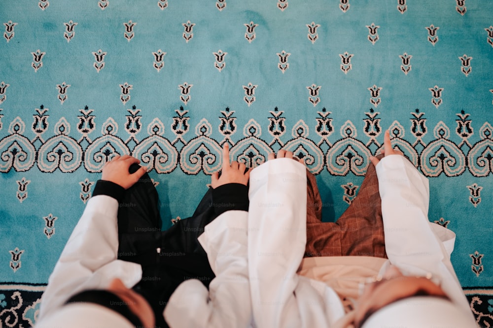 a person laying on a bed in front of a blue wall