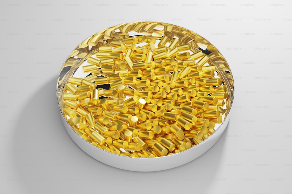 a bowl filled with yellow sprinkles on top of a white table