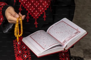 a person holding a rosary and a book