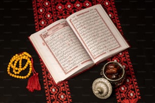 an open book sitting on top of a table next to a bowl of food