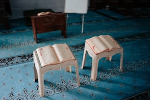 a couple of small wooden tables sitting on top of a blue rug