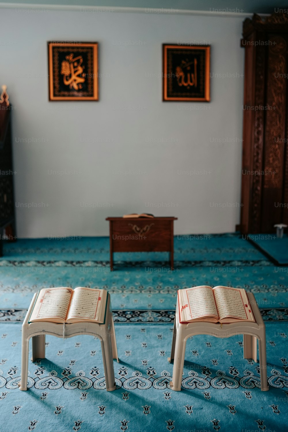two miniature stools sitting on a rug in a room