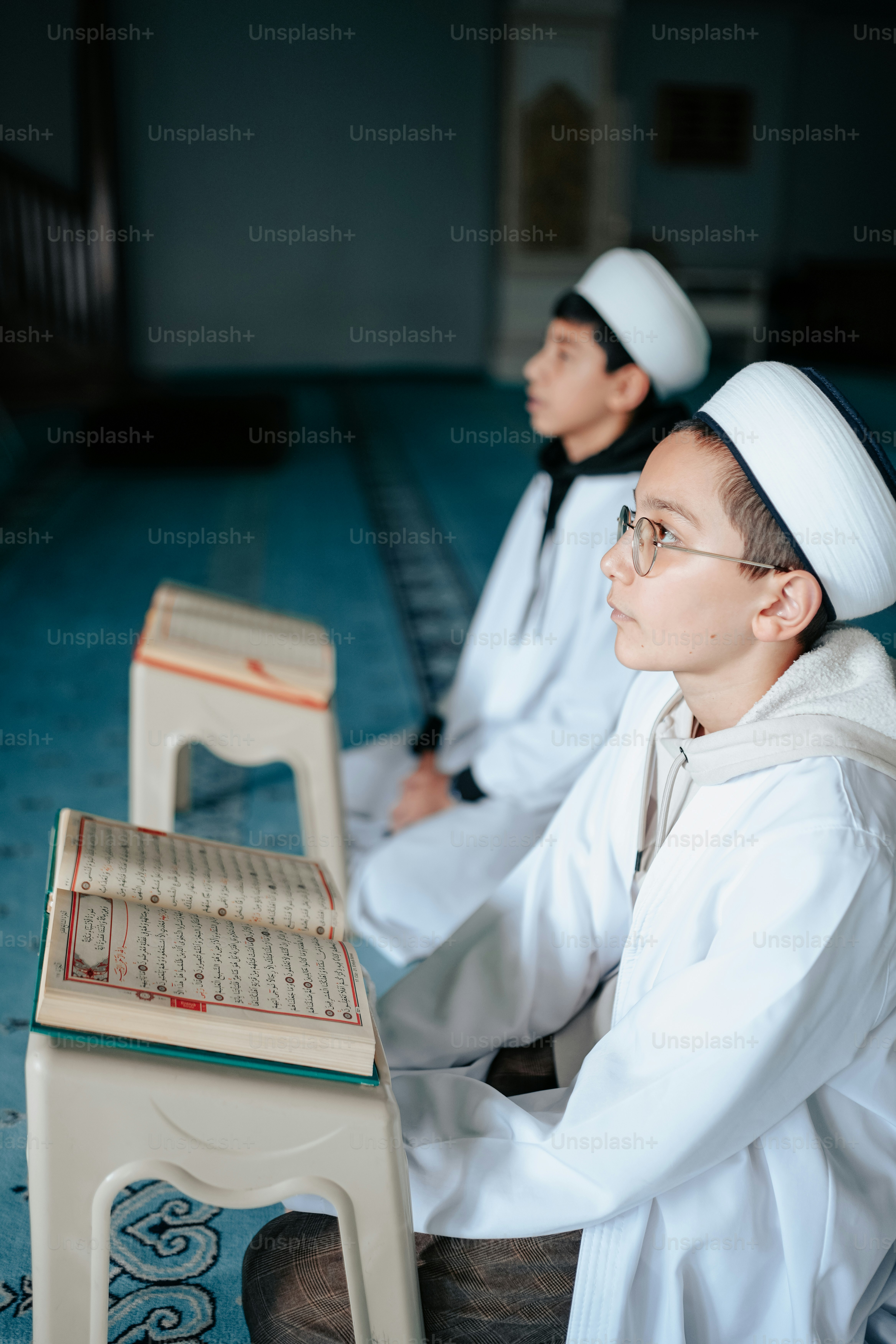 a couple of men sitting next to each other
