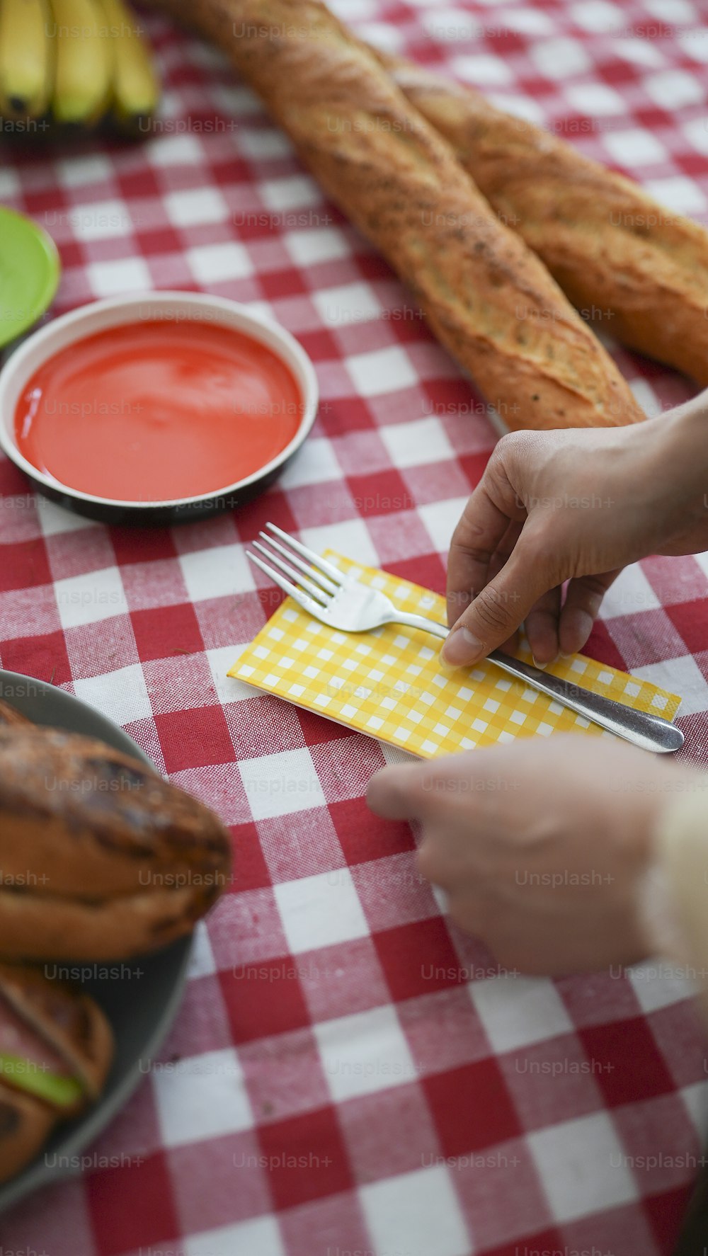 a person holding a fork near a plate of food