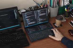 a person typing on a laptop on a desk