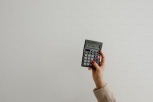 a person holding a calculator in their hand