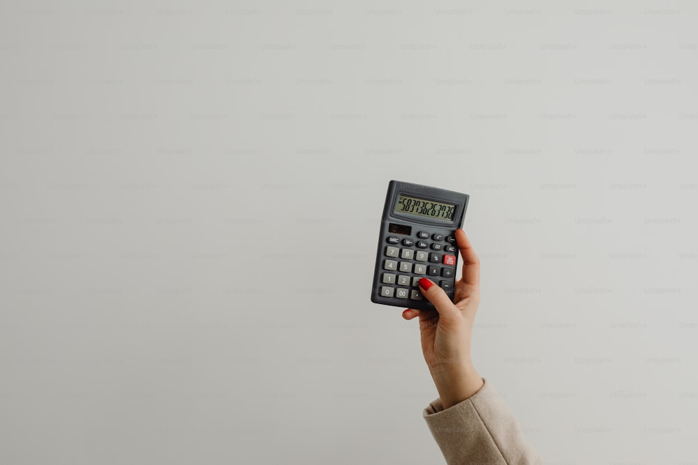 a person holding a calculator in their hand