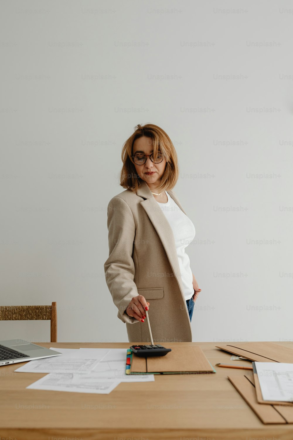 a woman standing in front of a wooden table