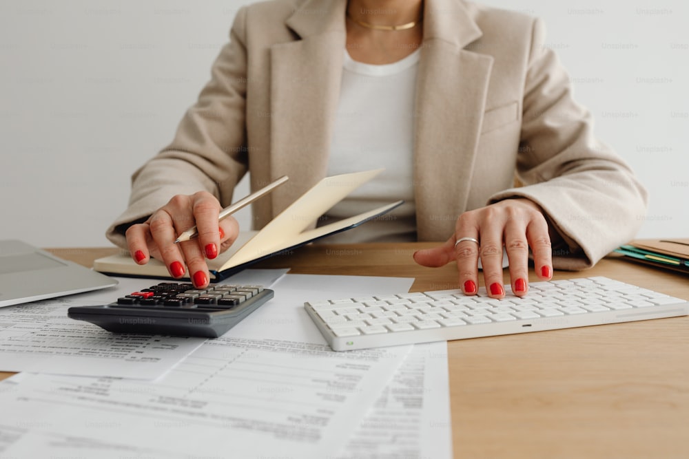 a woman sitting at a desk with a calculator