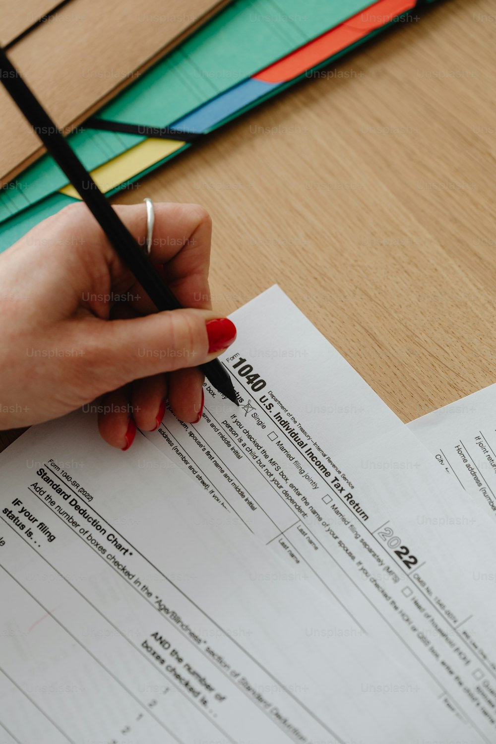 a person is writing on a piece of paper