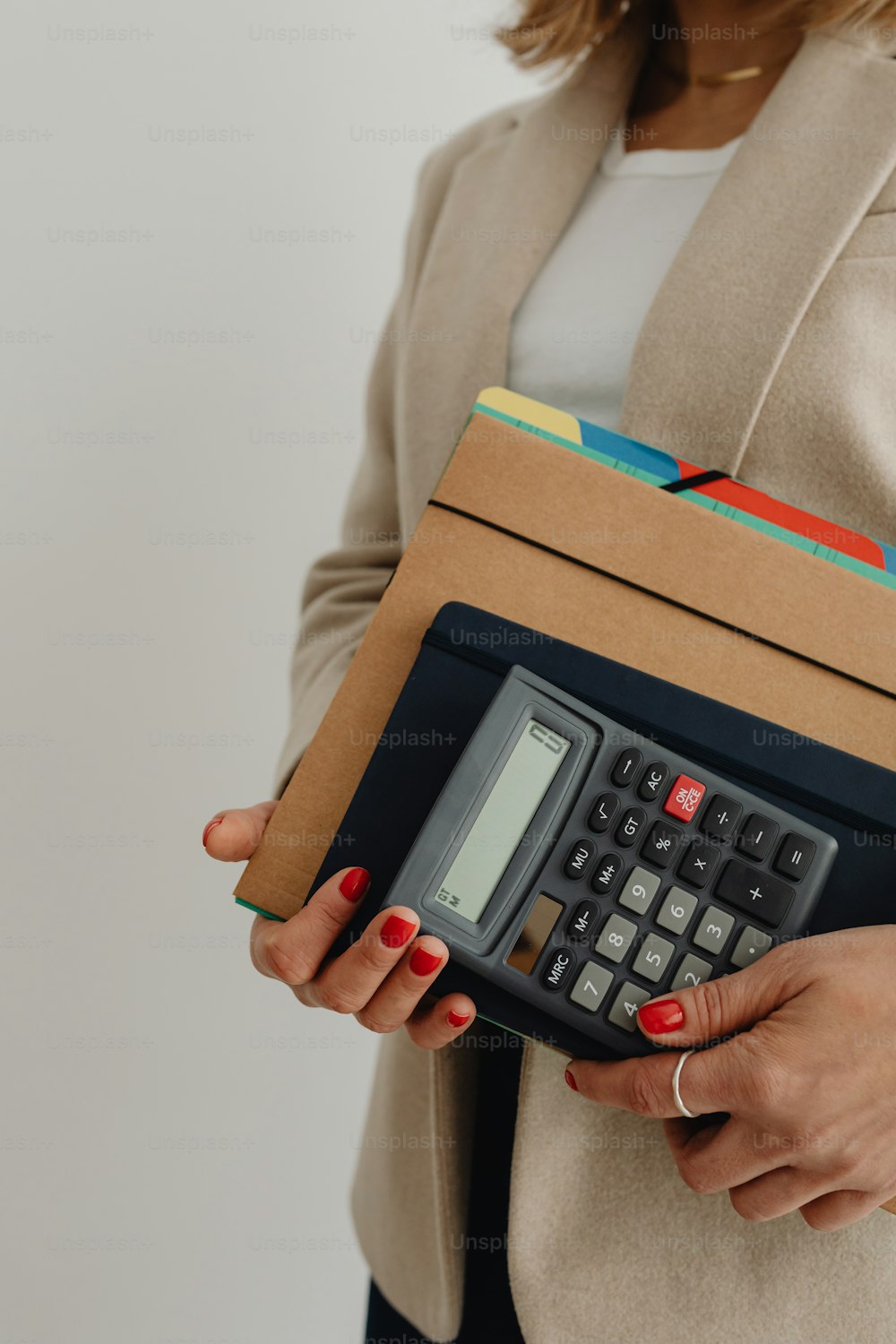 uma mulher segurando uma calculadora em suas mãos