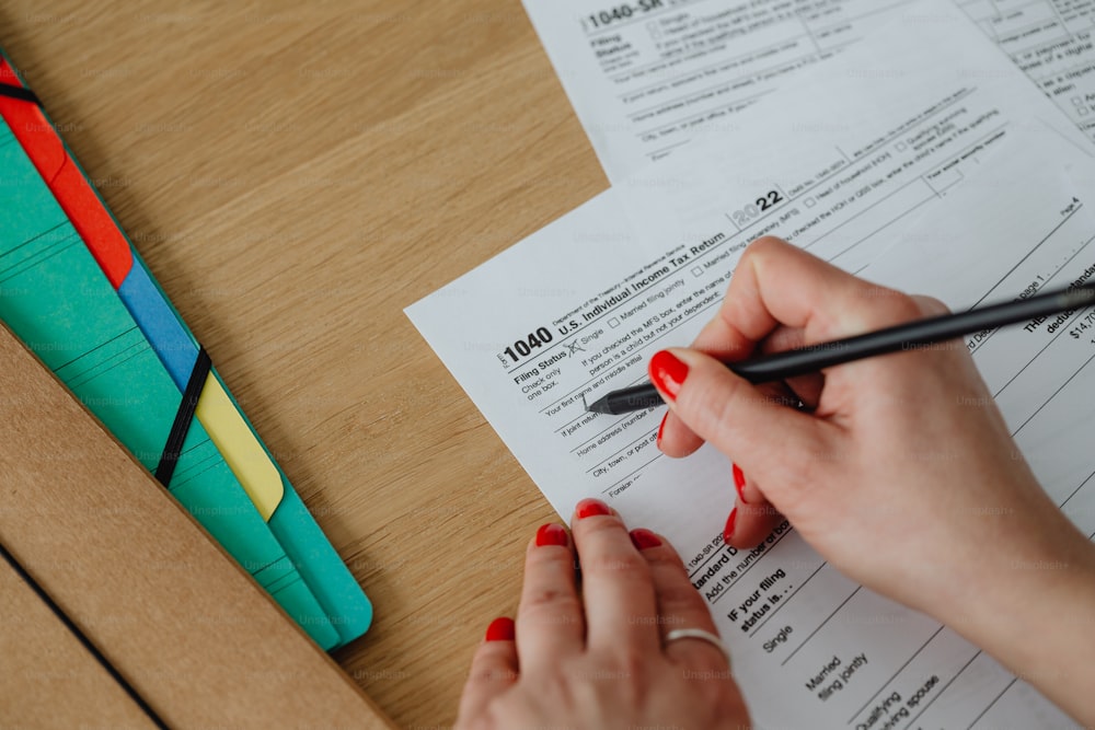 a woman is writing on a piece of paper