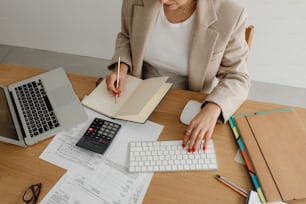 a woman sitting at a desk working on a computer