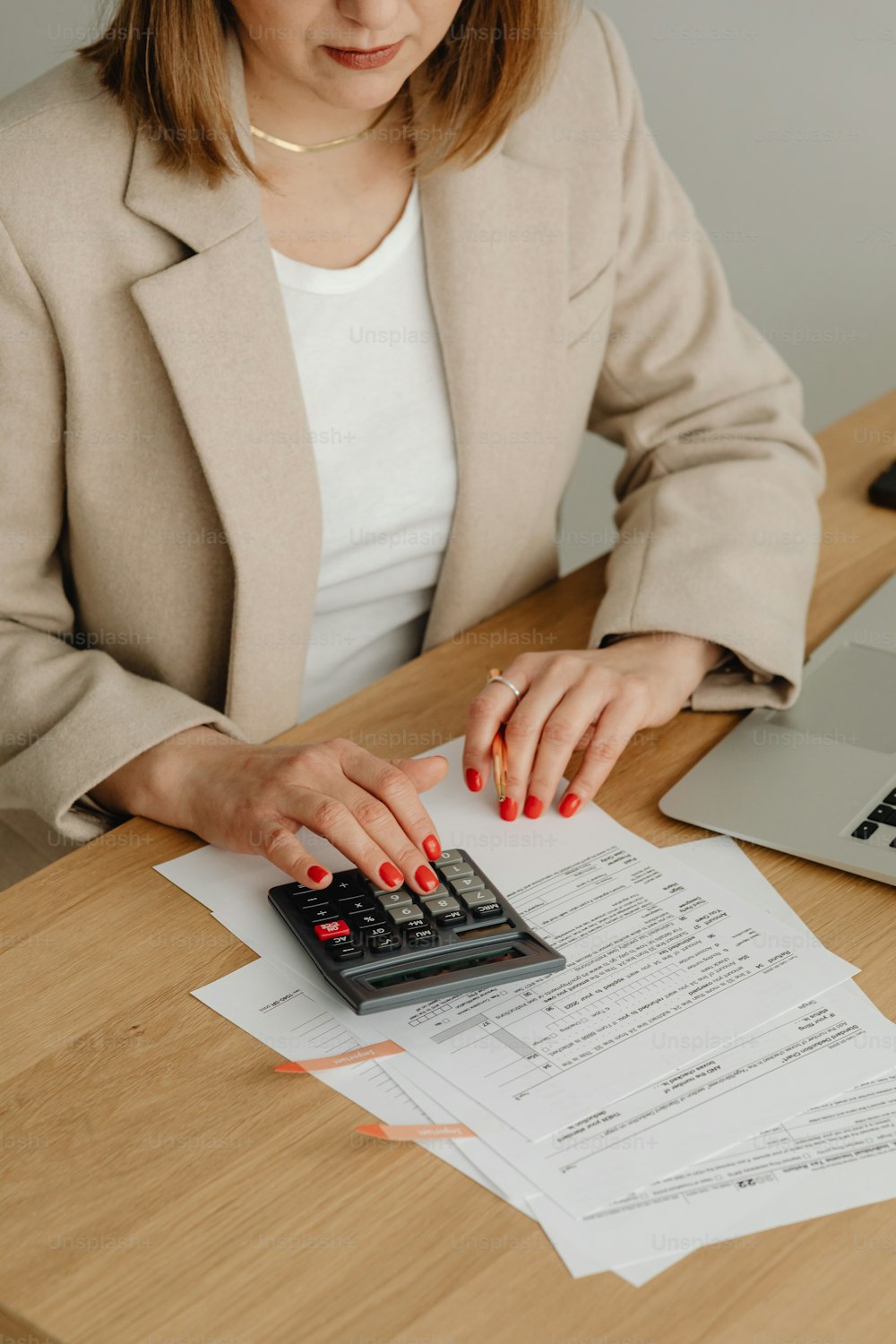 a woman sitting at a desk with a calculator