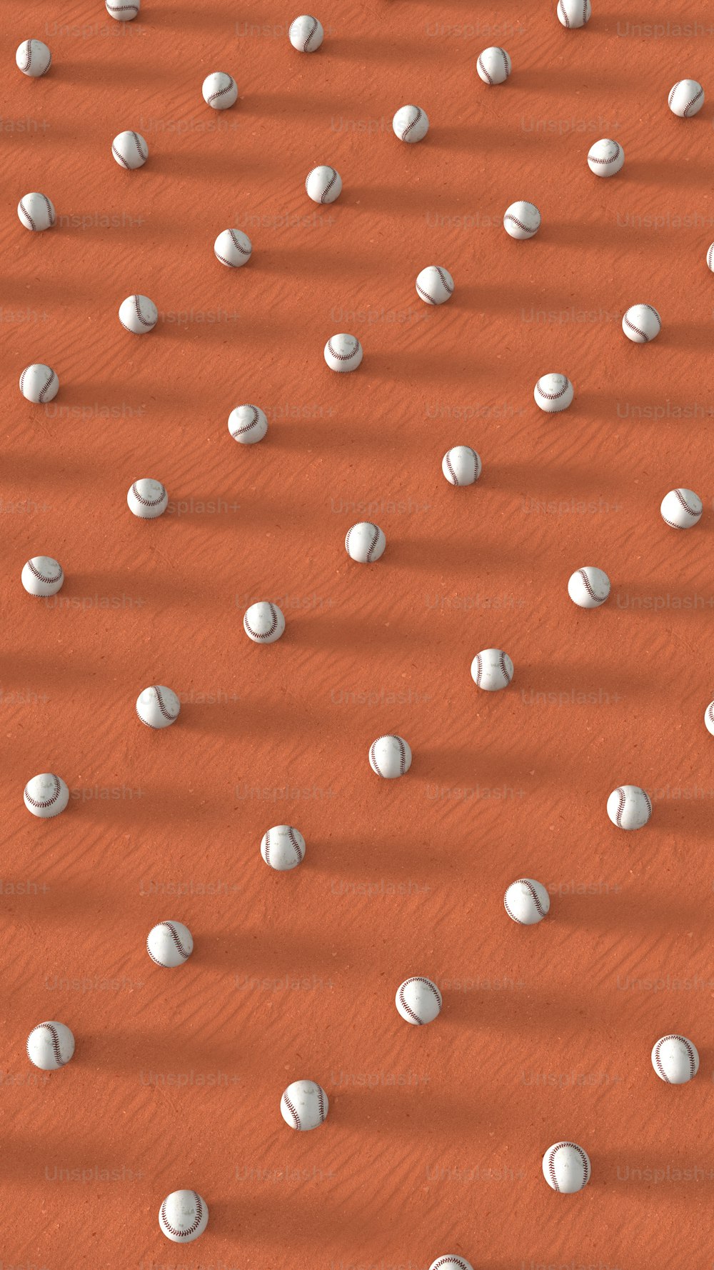 a group of white balls sitting on top of a sandy ground