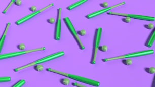 a group of green and white crayons on a purple background